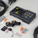 Knock Monitor V3 HD and all included accessories laid out, including sensor, cables, flash drive, and connectors.