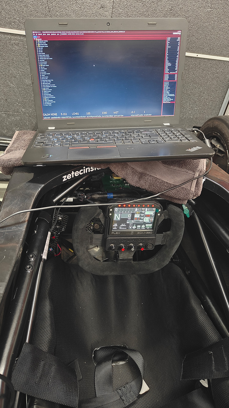 Graham Blackwell’s steering wheel with SDM-330 installed inside the car, laptop resting on chassis during setup