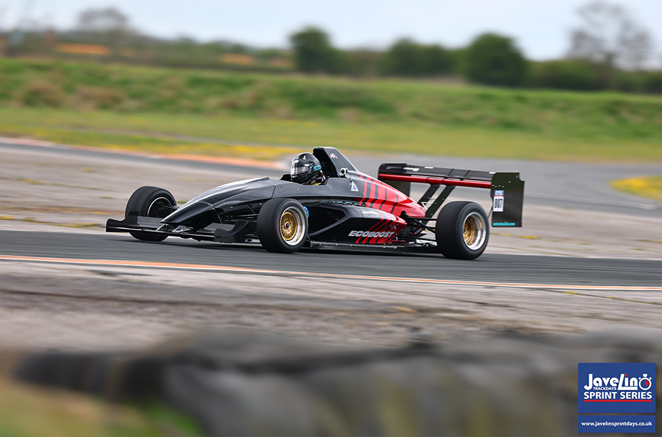 Graham Blackwell driving his Mygale sprint car on track wearing a helmet